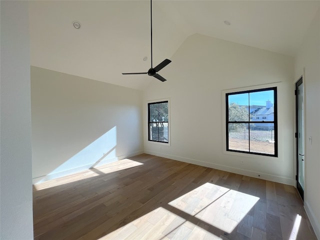 unfurnished room with hardwood / wood-style floors, high vaulted ceiling, ceiling fan, and a healthy amount of sunlight