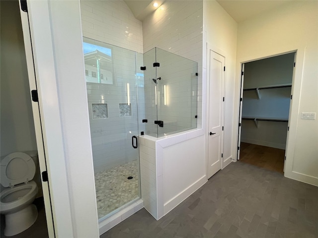 bathroom with toilet and walk in shower