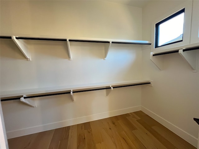 spacious closet with light hardwood / wood-style floors