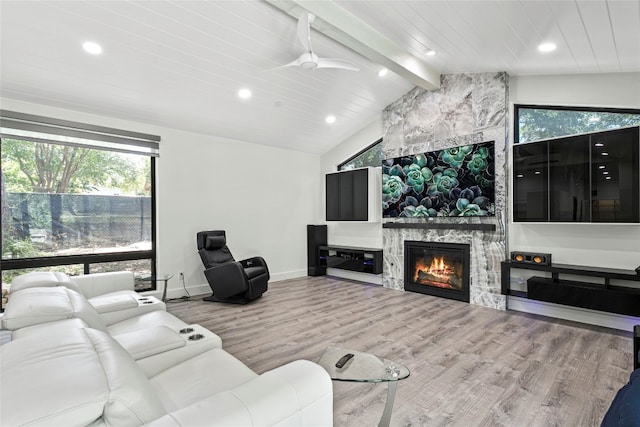 living room featuring ceiling fan, vaulted ceiling with beams, a fireplace, wood ceiling, and hardwood / wood-style flooring