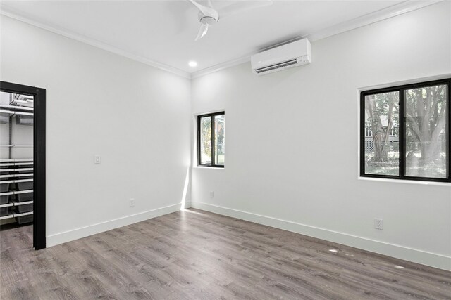 5110 Sioux Ln, Austin, TX 78734 - empty room with a wall mounted air conditioner, ornamental molding, wood finished floors, and recessed lighting