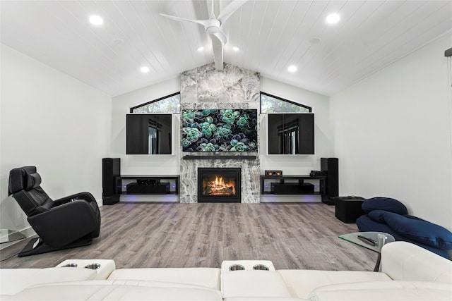 living room featuring lofted ceiling with beams, wood-type flooring, a fireplace, and wooden ceiling