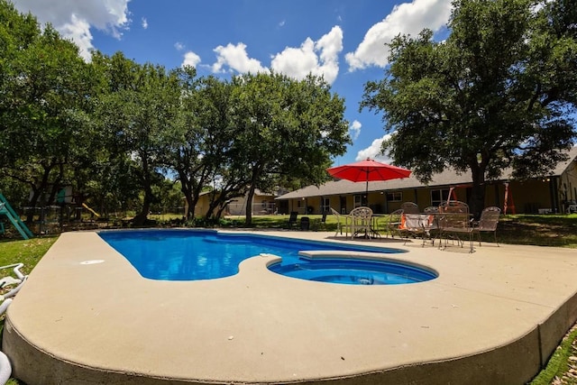 view of swimming pool with a patio and a playground