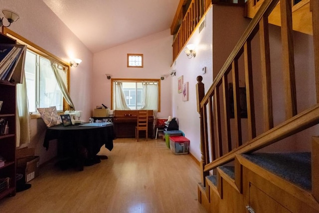 interior space with light hardwood / wood-style flooring and lofted ceiling