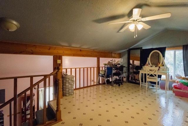 bonus room with ceiling fan, lofted ceiling, and a textured ceiling