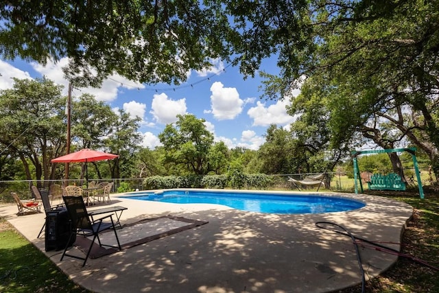 view of swimming pool with a patio