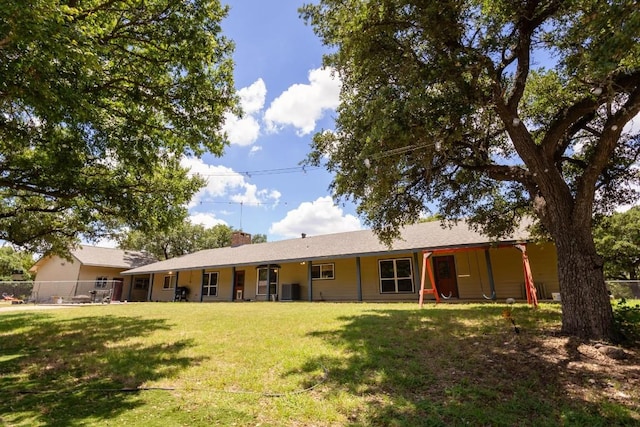 rear view of property with a lawn