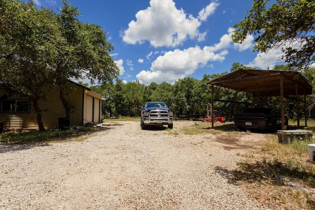 view of vehicle parking with a carport and a garage