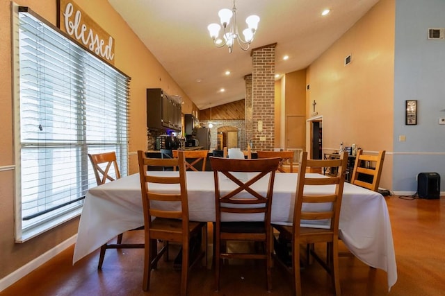 dining space featuring a notable chandelier and high vaulted ceiling