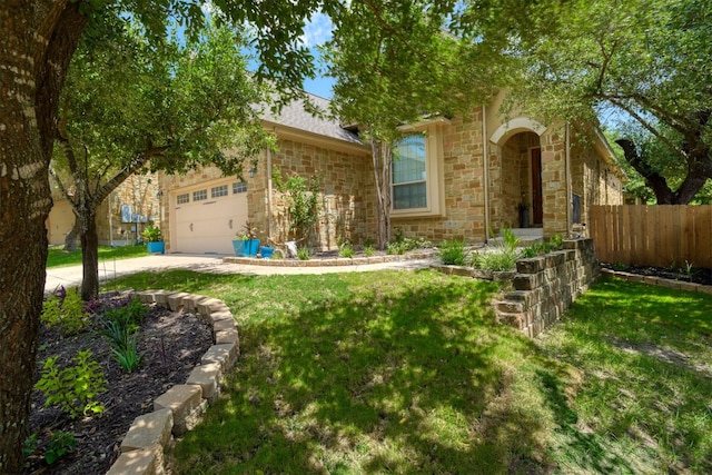 view of front of house featuring a front lawn and a garage