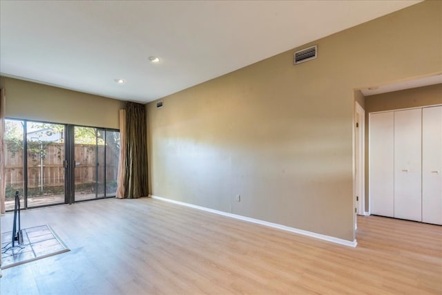 spare room with light hardwood / wood-style flooring