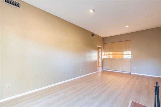 spare room with light wood-type flooring