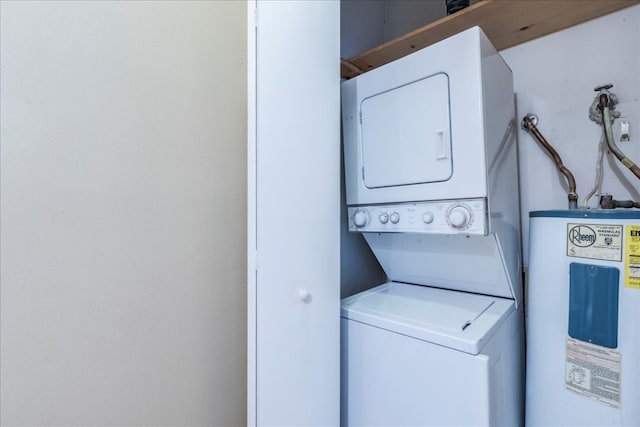 laundry area with water heater and stacked washer and clothes dryer