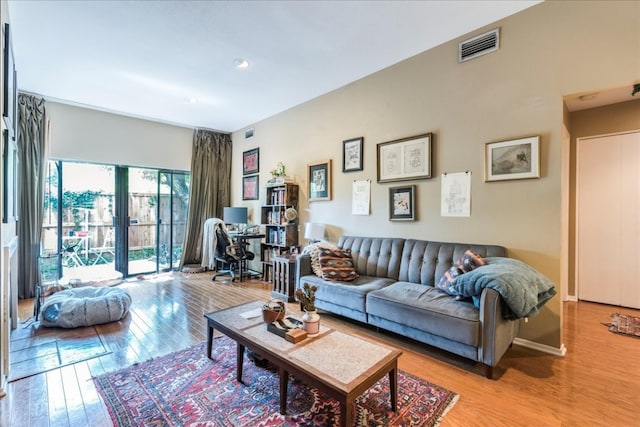 living room featuring french doors and light hardwood / wood-style floors