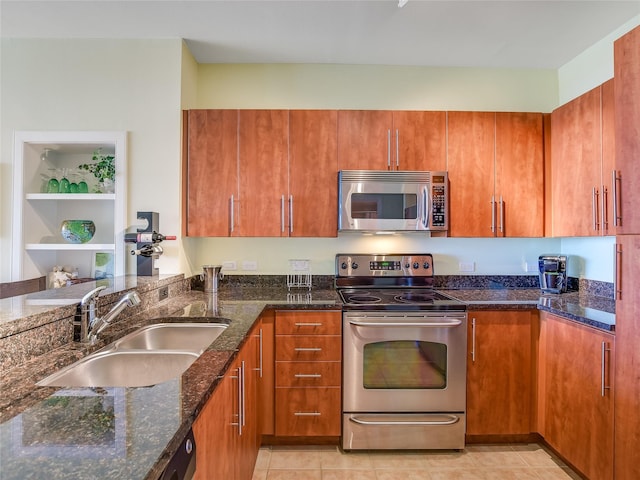 kitchen featuring stainless steel appliances, dark stone countertops, light tile patterned flooring, and sink