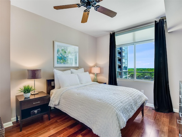 bedroom with ceiling fan and dark hardwood / wood-style floors