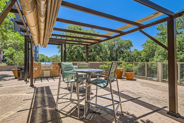 view of patio / terrace featuring exterior kitchen and a pergola