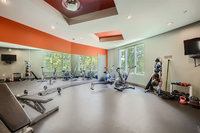 gym with a tray ceiling