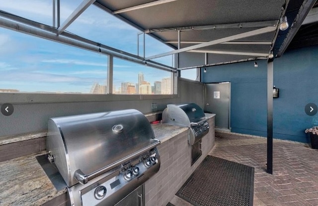 view of patio / terrace featuring exterior kitchen and a grill