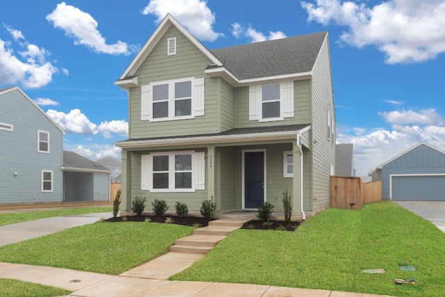 view of front of property featuring a garage, an outdoor structure, and a front lawn