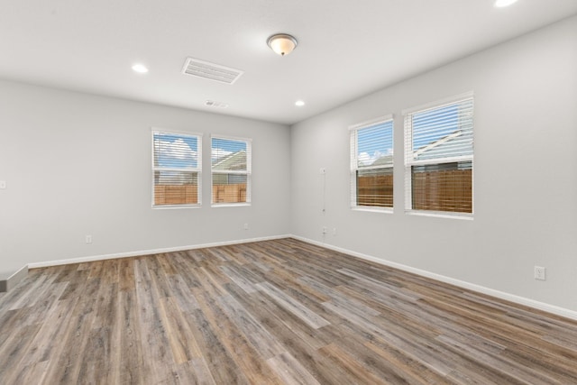 unfurnished room featuring hardwood / wood-style floors