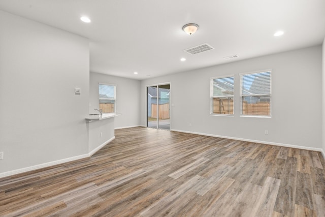 empty room featuring sink and light hardwood / wood-style flooring