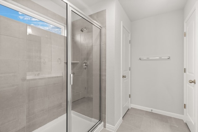 bathroom with walk in shower and tile patterned floors