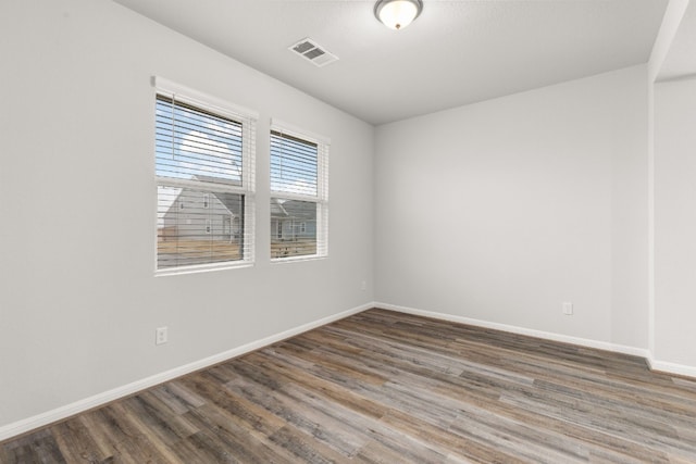 unfurnished room featuring dark hardwood / wood-style floors