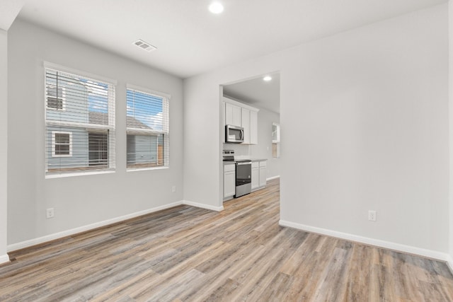 unfurnished living room with light hardwood / wood-style floors