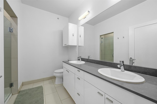 bathroom featuring vanity, toilet, tile patterned floors, and walk in shower