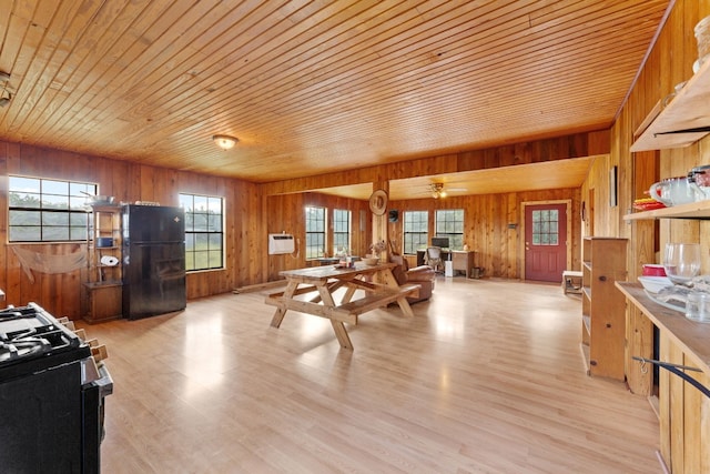 kitchen with range, wood walls, light hardwood / wood-style flooring, and wooden ceiling