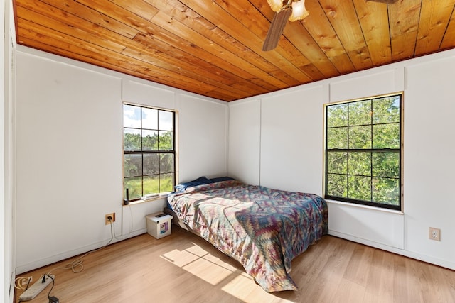 bedroom featuring multiple windows, light wood-type flooring, and ceiling fan