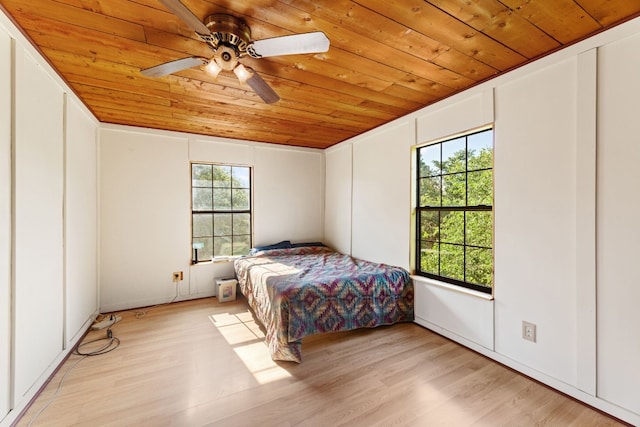 bedroom with light hardwood / wood-style flooring and multiple windows