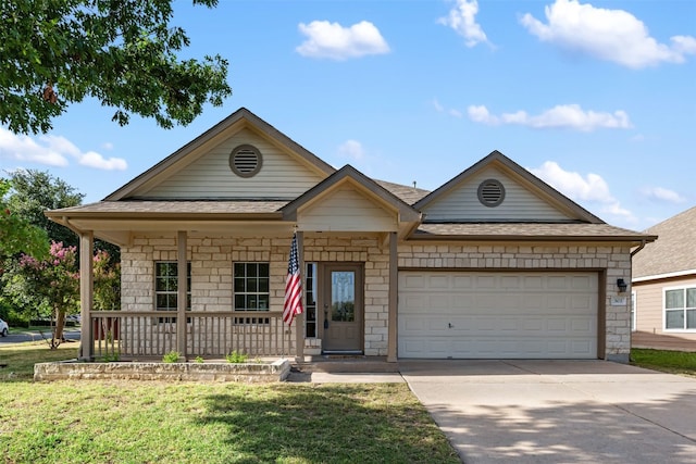 view of front of property with a porch, a garage, and a front lawn