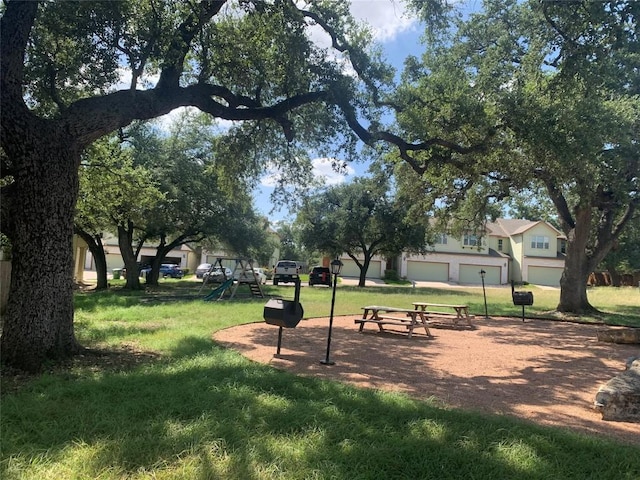 surrounding community with playground community and a yard