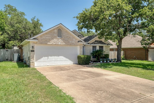 view of front facade with a garage, a front yard, and central AC