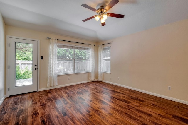 interior space with a healthy amount of sunlight, ceiling fan, and dark wood-type flooring