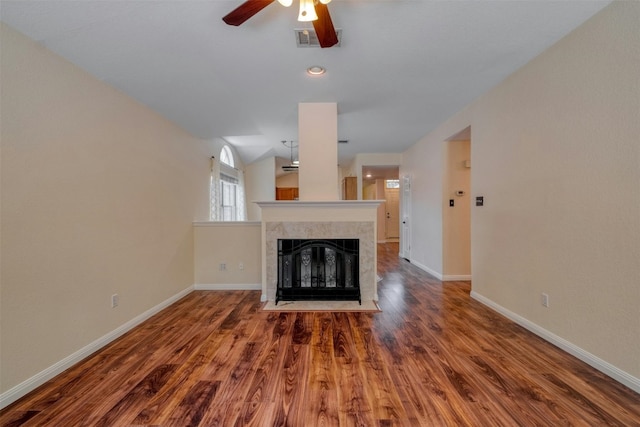 unfurnished living room with a premium fireplace, hardwood / wood-style floors, ceiling fan, and vaulted ceiling