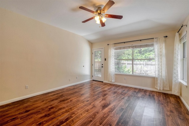 unfurnished room featuring ceiling fan, dark wood-type flooring, and vaulted ceiling