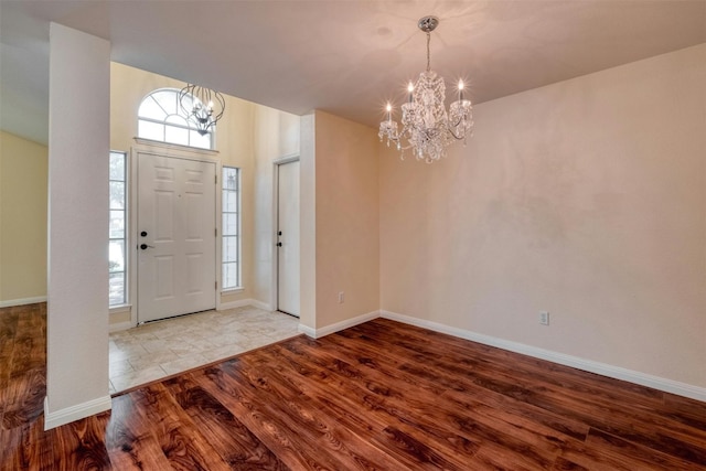 foyer with hardwood / wood-style floors and a chandelier