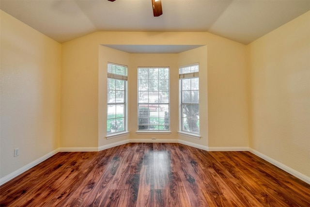 empty room with ceiling fan, dark wood-type flooring, and vaulted ceiling