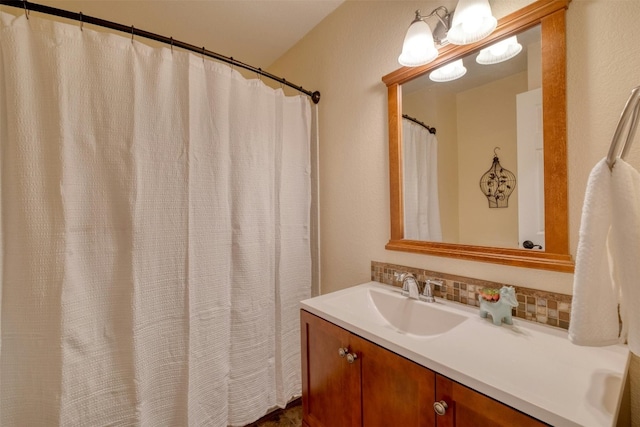 bathroom with tasteful backsplash and vanity