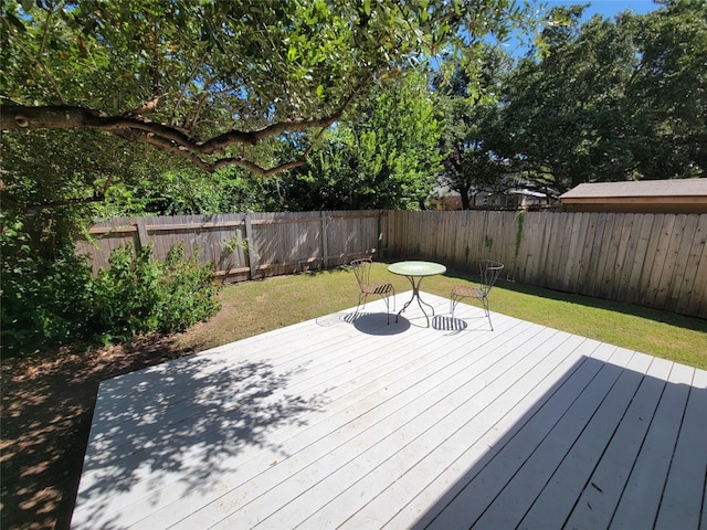 wooden deck with a lawn