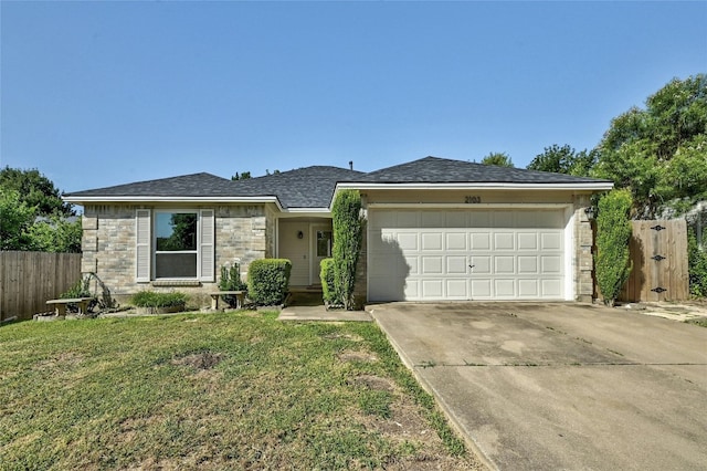 view of front of property with a garage and a front yard