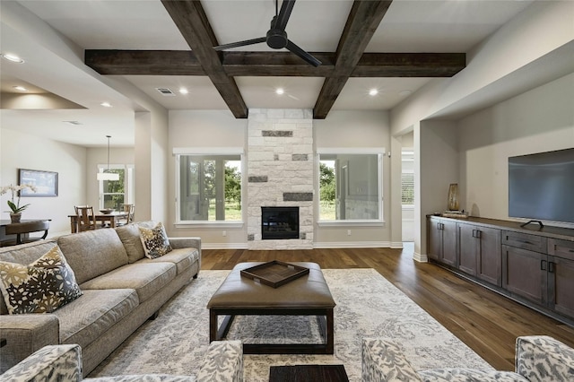 living room featuring beam ceiling, a wealth of natural light, dark wood-type flooring, and coffered ceiling