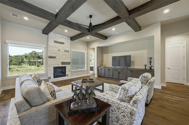 living room featuring beamed ceiling, dark hardwood / wood-style floors, ceiling fan, and a fireplace