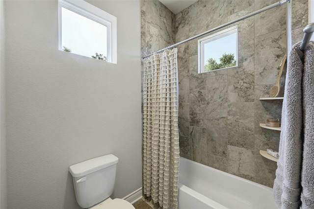 bathroom featuring shower / bath combo and toilet