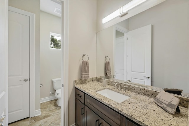 bathroom featuring vanity and toilet