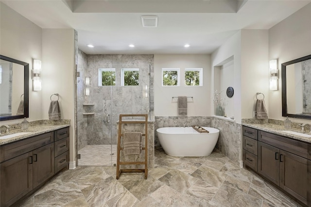 bathroom featuring vanity, plus walk in shower, and tile walls