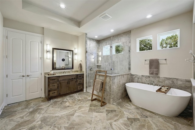 bathroom featuring a raised ceiling, vanity, tile walls, and shower with separate bathtub